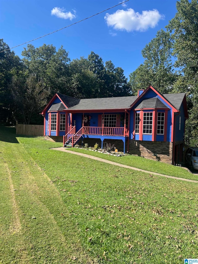 ranch-style house with a front lawn and a porch