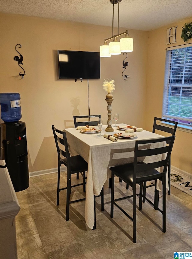 dining area featuring a textured ceiling