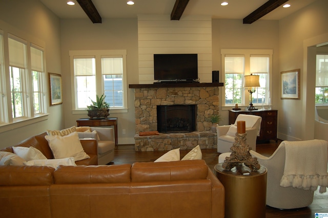 living room featuring a wealth of natural light, beam ceiling, and dark hardwood / wood-style flooring