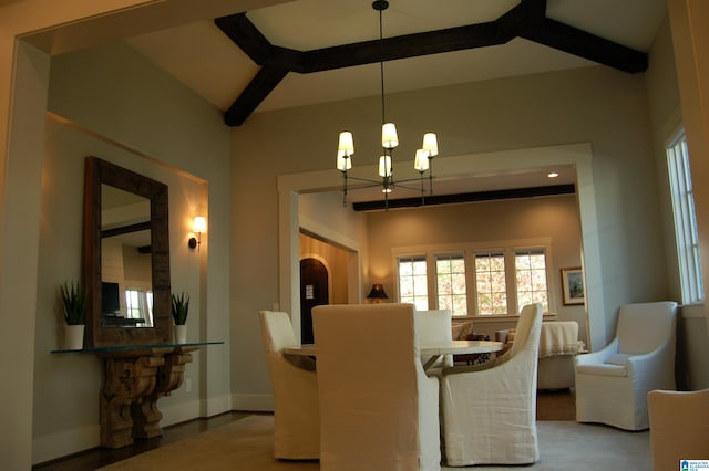 dining room with beamed ceiling and an inviting chandelier