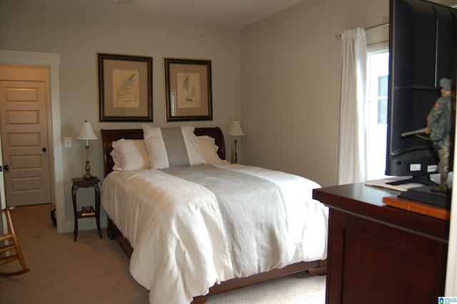 bedroom featuring light carpet