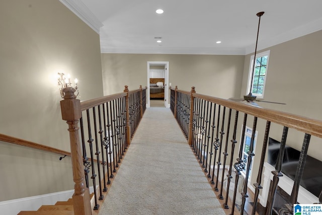 hall featuring light colored carpet and crown molding