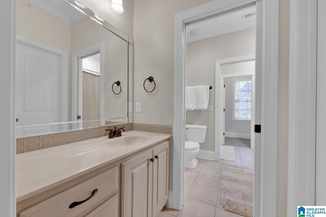 bathroom featuring toilet, vanity, and tile patterned flooring