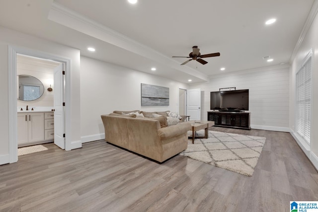 living room with ornamental molding, ceiling fan, sink, and light hardwood / wood-style floors