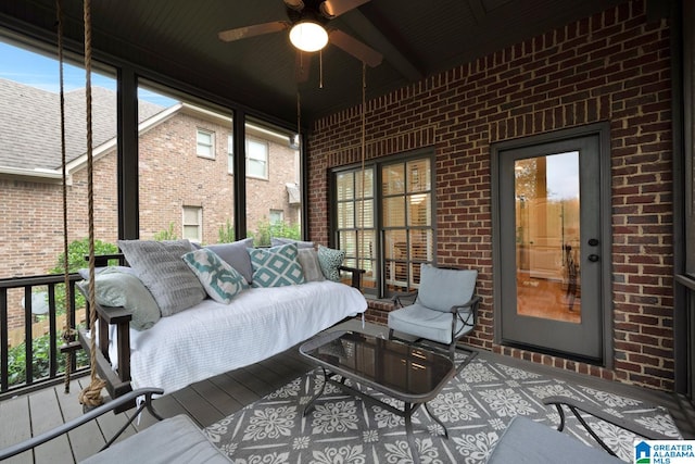 sunroom featuring ceiling fan