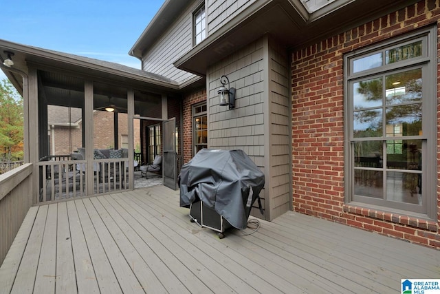 wooden terrace featuring area for grilling and a sunroom