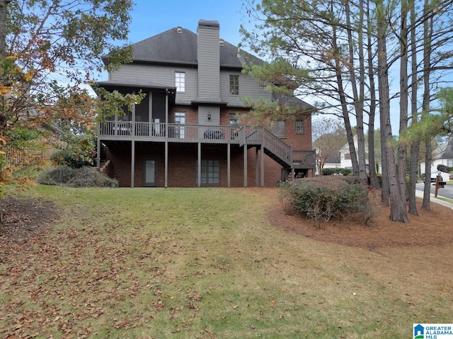 back of house featuring a deck and a yard