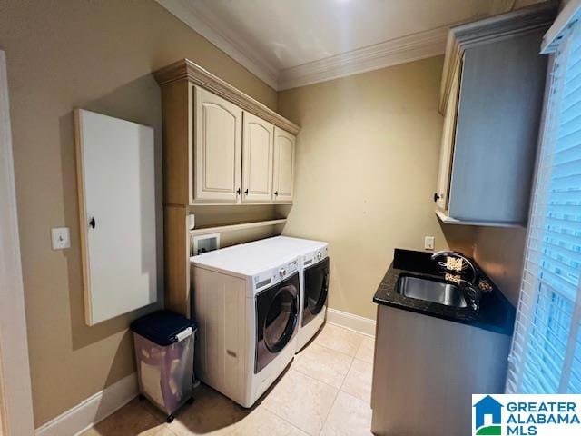 laundry room featuring separate washer and dryer, cabinets, sink, ornamental molding, and light tile patterned flooring