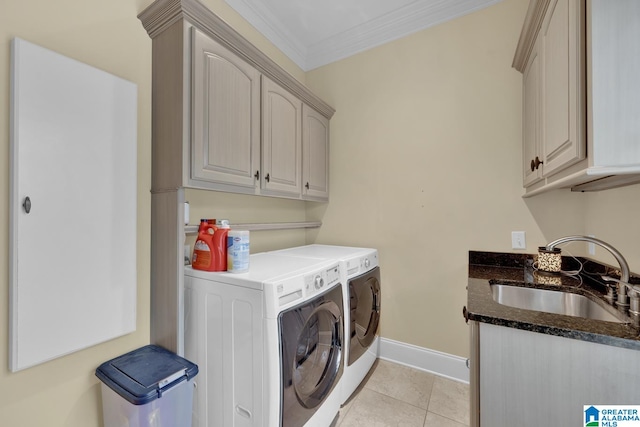 laundry room featuring cabinets, sink, light tile patterned floors, crown molding, and washing machine and clothes dryer