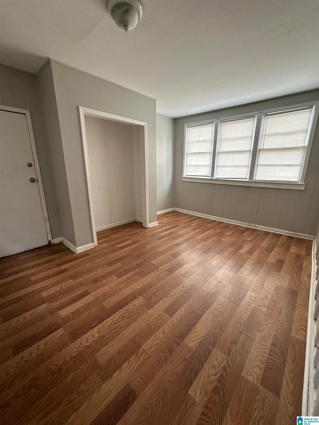 unfurnished bedroom with wood-type flooring and a closet