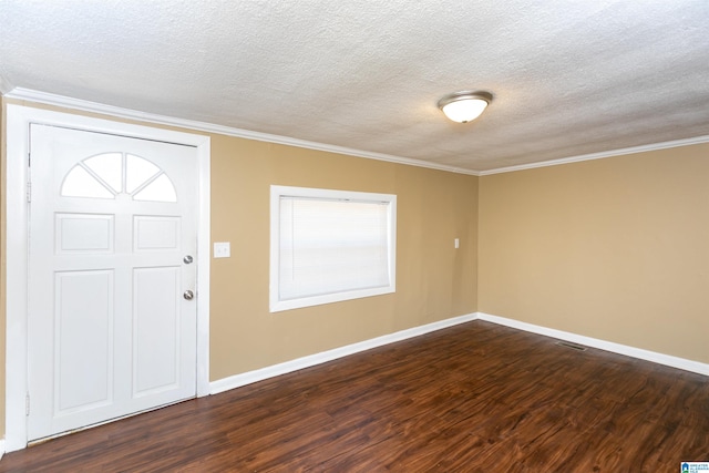 foyer entrance featuring dark wood-type flooring, a textured ceiling, and crown molding