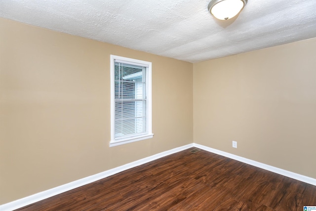 unfurnished room featuring wood-type flooring and a textured ceiling