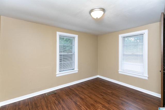 empty room featuring dark hardwood / wood-style flooring