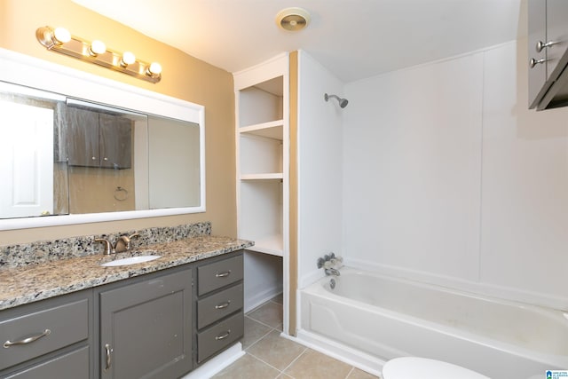 full bathroom with vanity, washtub / shower combination, tile patterned flooring, and toilet