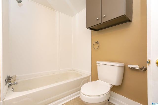 bathroom with a tub to relax in and toilet