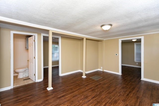 basement with a textured ceiling and dark hardwood / wood-style floors