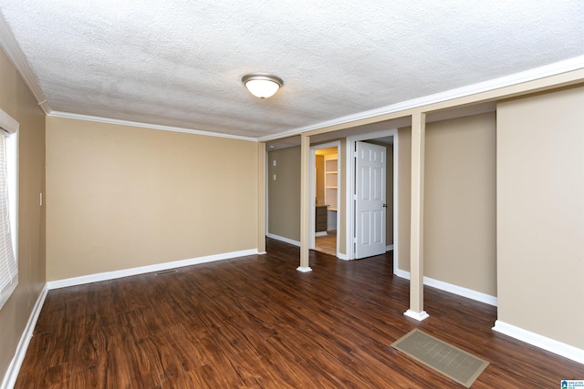 interior space featuring dark wood-type flooring, a textured ceiling, and crown molding