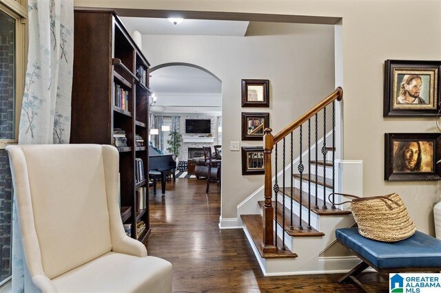 110 Sterling Lakes Dr, Helena, AL 35080 - stairs with arched walkways, wood finished floors, a large fireplace, and baseboards