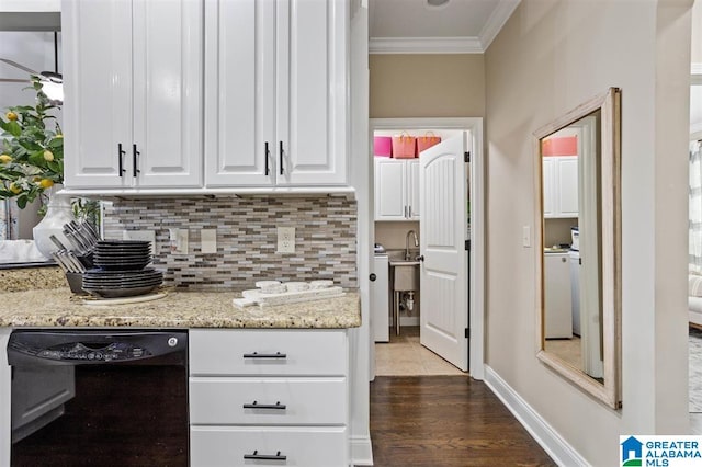 kitchen featuring ornamental molding, white cabinetry, black dishwasher, dark hardwood / wood-style flooring, and light stone countertops