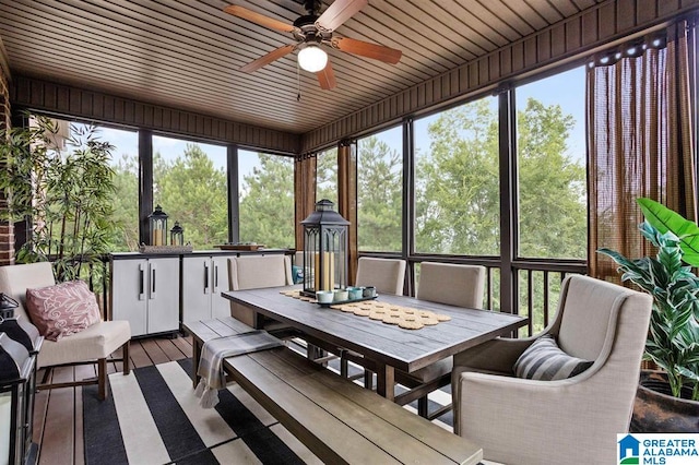 sunroom with ceiling fan and wooden ceiling