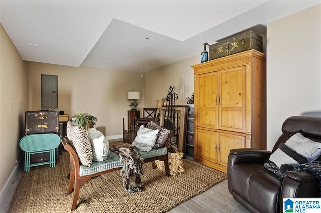 sitting room featuring electric panel and light hardwood / wood-style flooring