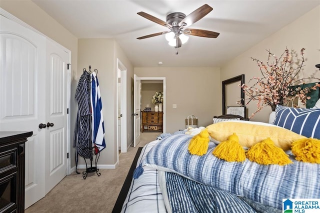 bedroom featuring a closet, light carpet, and ceiling fan