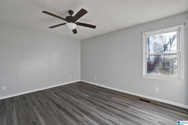 spare room with ceiling fan, dark hardwood / wood-style flooring, and a textured ceiling