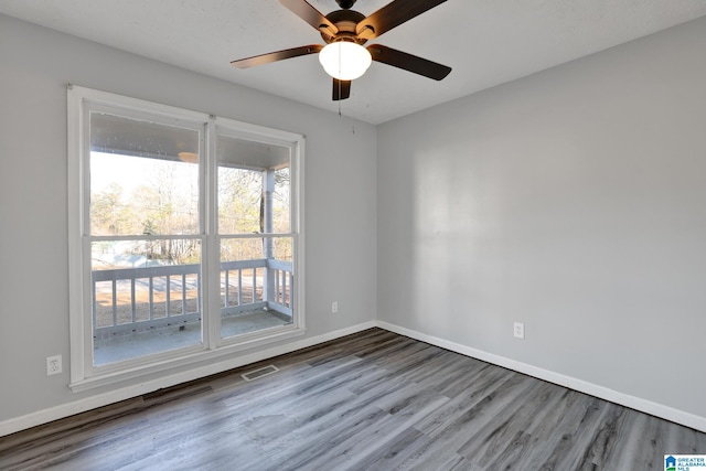 unfurnished room with hardwood / wood-style flooring, plenty of natural light, and ceiling fan