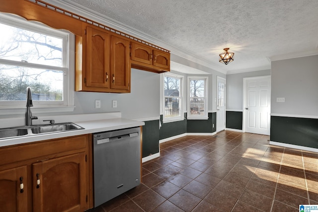 kitchen featuring dishwasher, crown molding, sink, dark tile patterned floors, and a textured ceiling