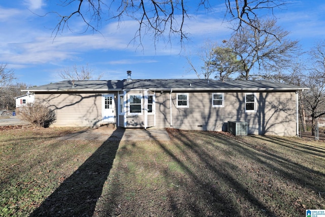 rear view of house featuring a lawn and central AC