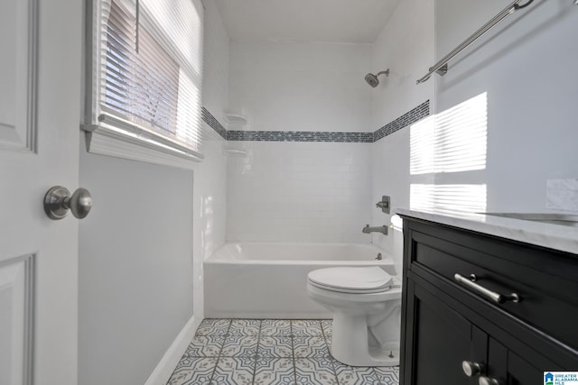 full bathroom featuring toilet, vanity, tiled shower / bath combo, and tile patterned floors