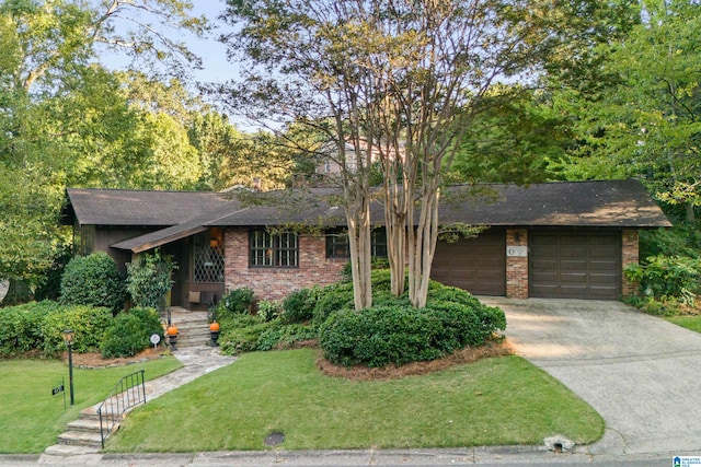 ranch-style house with a garage and a front lawn