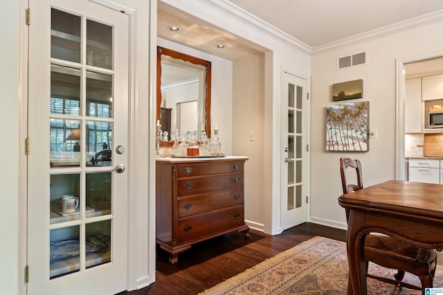 interior space with dark hardwood / wood-style flooring and crown molding