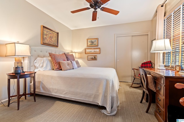 carpeted bedroom featuring ceiling fan and a closet