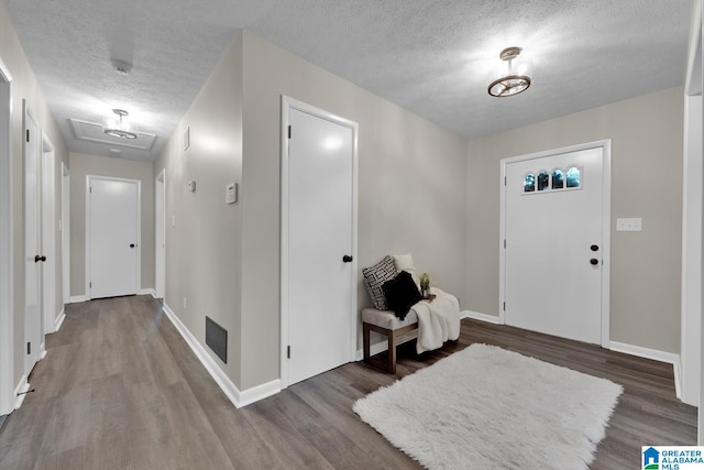 foyer entrance with a textured ceiling and hardwood / wood-style flooring