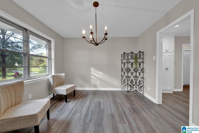 living area featuring hardwood / wood-style floors and a notable chandelier