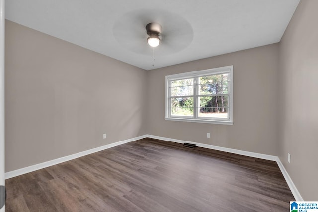 spare room featuring ceiling fan and dark hardwood / wood-style flooring