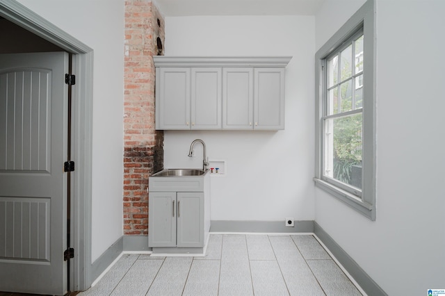 laundry room featuring hookup for a washing machine, cabinets, sink, and hookup for an electric dryer