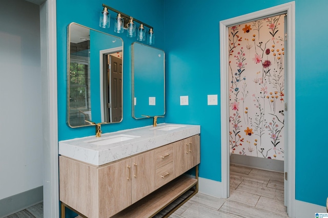 1031 S 26th St, Birmingham, AL 35205 - bathroom featuring a shower with shower curtain, double vanity, and baseboards