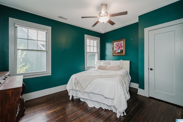 bedroom featuring ornamental molding, dark hardwood / wood-style flooring, and ceiling fan