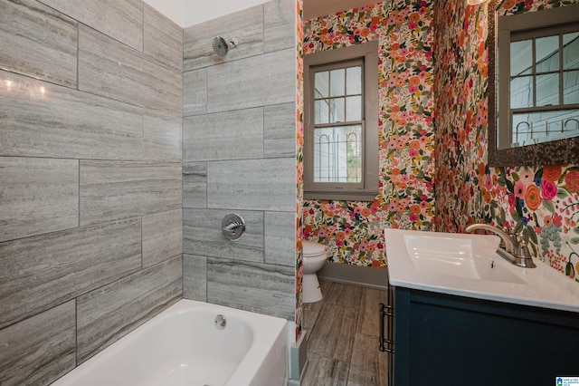 bathroom featuring toilet, a washtub, vanity, and hardwood / wood-style floors