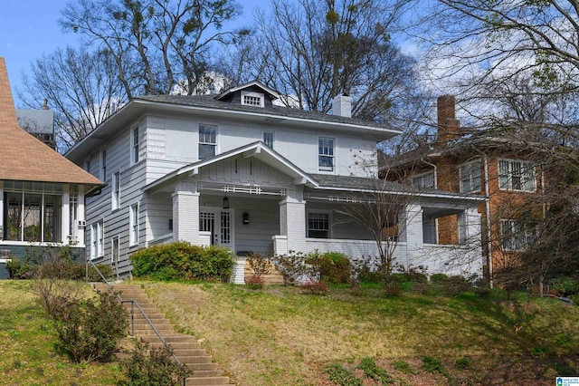 1031 S 26th St, Birmingham, AL 35205 - american foursquare style home featuring stairs, a front lawn, covered porch, and board and batten siding