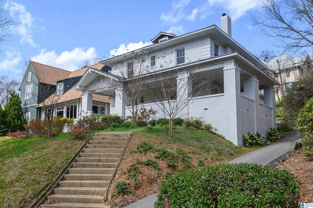 1031 S 26th St, Birmingham, AL 35205 - view of front facade with a chimney, stairway, and brick siding