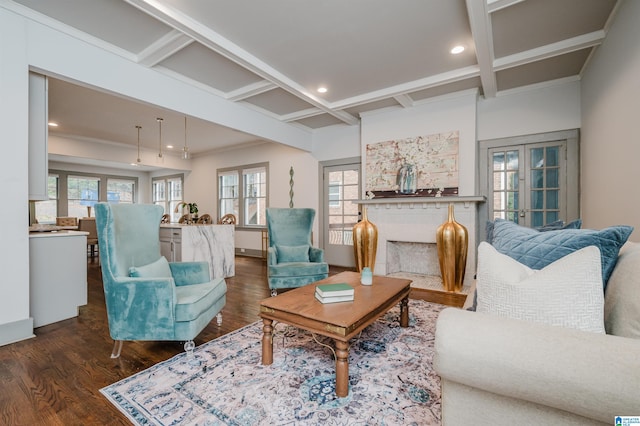 living room featuring dark hardwood / wood-style flooring, beamed ceiling, crown molding, and plenty of natural light