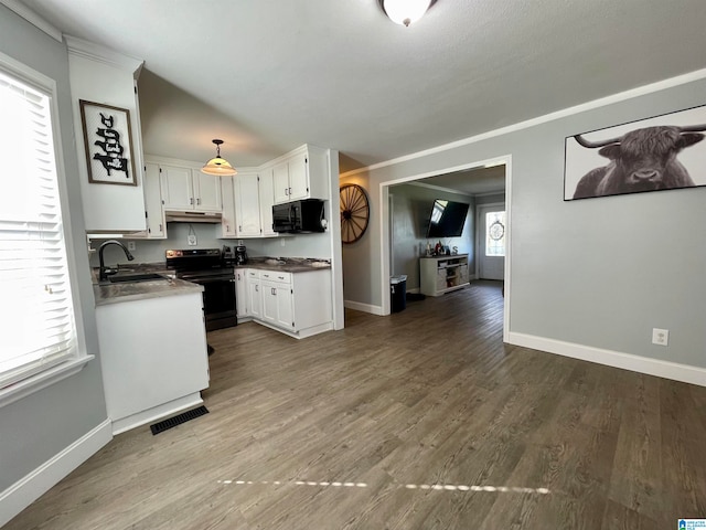 kitchen featuring hardwood / wood-style floors, black appliances, sink, white cabinetry, and decorative light fixtures