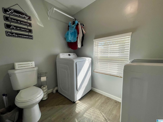 washroom featuring wood-type flooring and washer / dryer