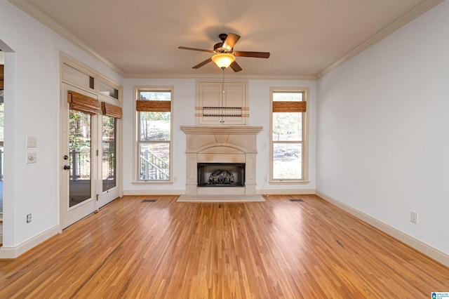 unfurnished living room featuring ceiling fan, light wood-type flooring, and crown molding