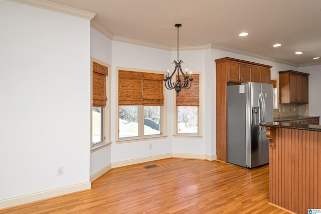 kitchen featuring crown molding, hanging light fixtures, light hardwood / wood-style floors, stainless steel fridge with ice dispenser, and a chandelier