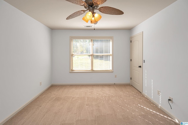 unfurnished room featuring ceiling fan and light carpet