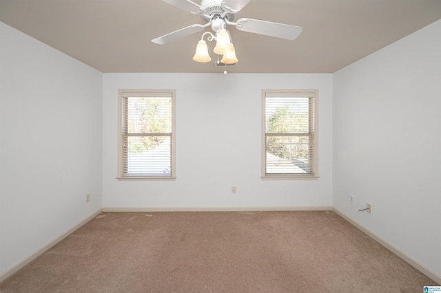 carpeted spare room with ceiling fan and a healthy amount of sunlight